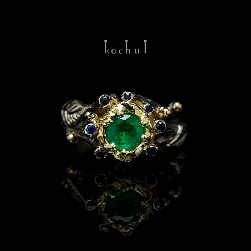 Engagement ring "The Triumph of Life". White, yellow gold, emerald, sapphires, black rhodium