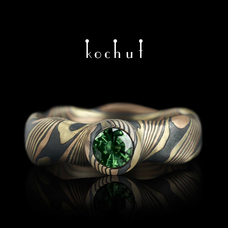 Seamless mokume ring «Polar lights». Yellow and red gold, etched silver, sapphire green, oxidized