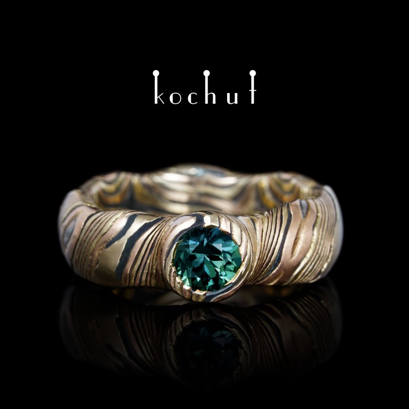 Seamless mokume ring «Polar lights». Yellow and red gold, etched silver, sapphire green