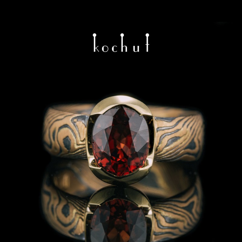 Ring mocume «Sophora». Red and yellow gold, etched silver, oxidation, garnet